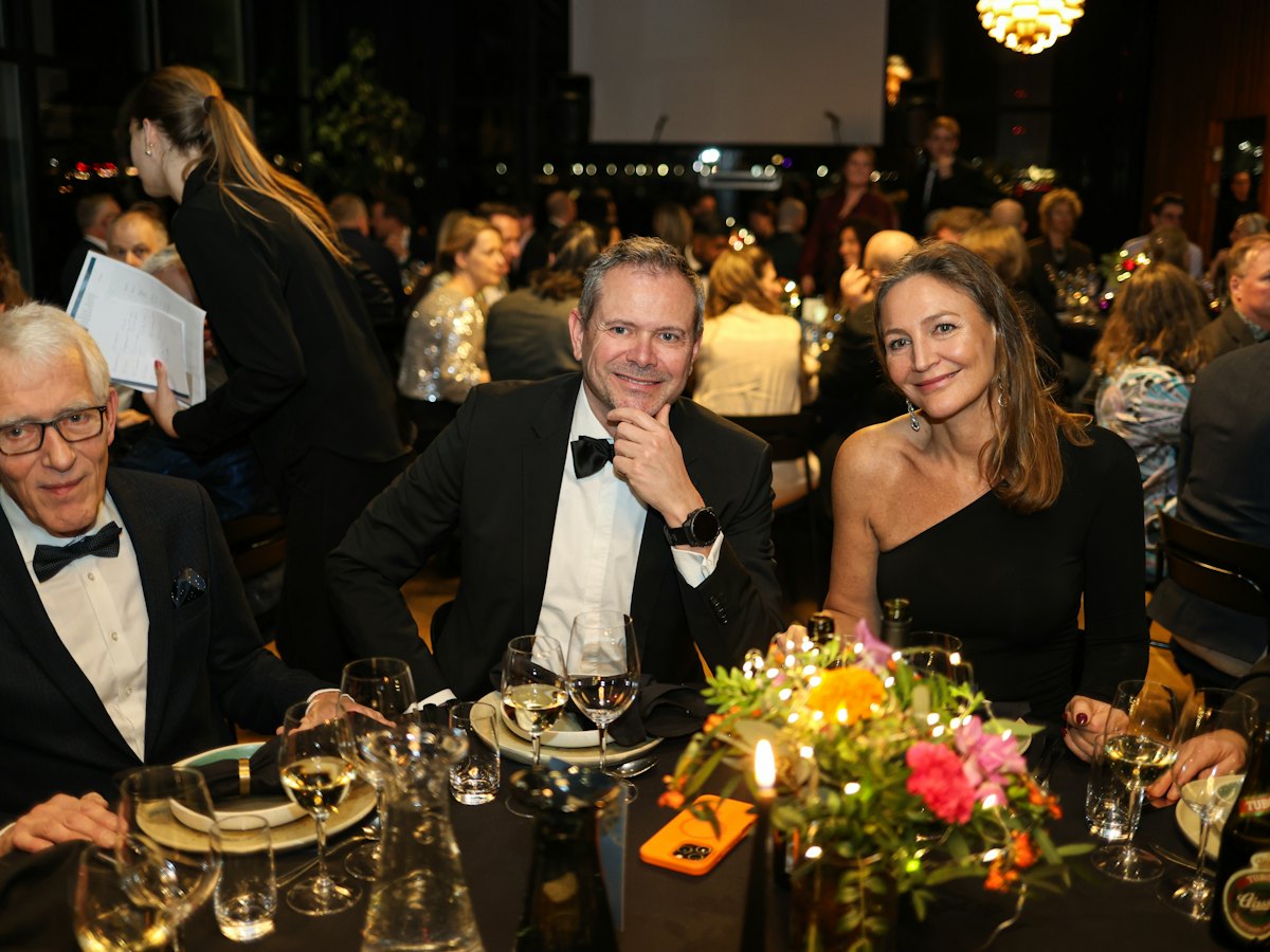 Guests in black tie at a formal sports dinner