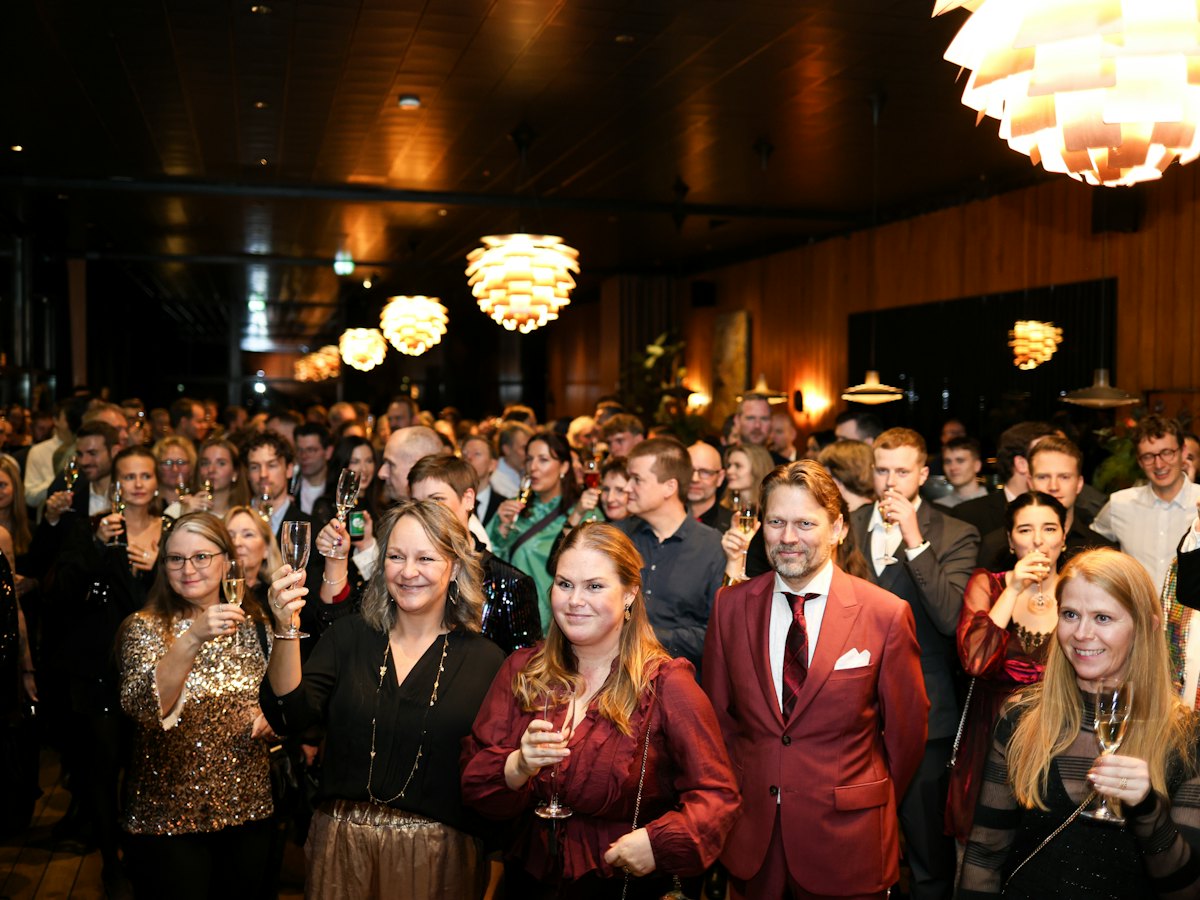 A busy function room full of guests at an evening event